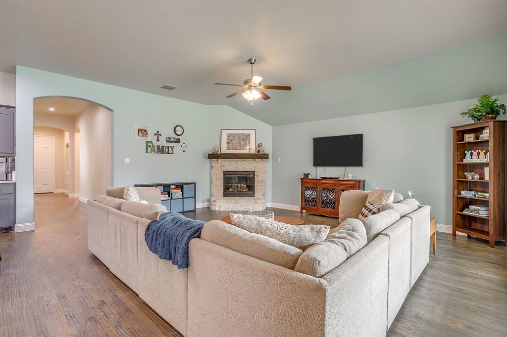15141 Fleet Hill Road Aledo, TX 76008 - Photo 37 of 37 a living room with furniture a fireplace and a flat screen tv