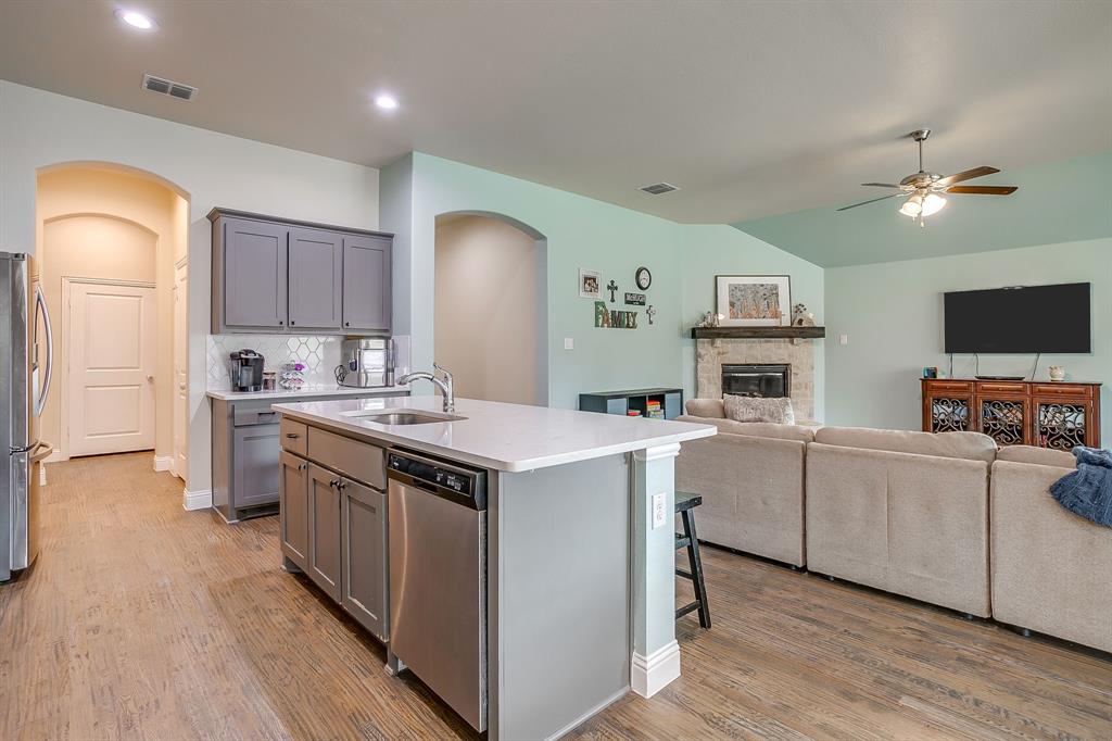15141 Fleet Hill Road Aledo, TX 76008 - Photo 8 of 37 a kitchen with a sink stove and wooden floor