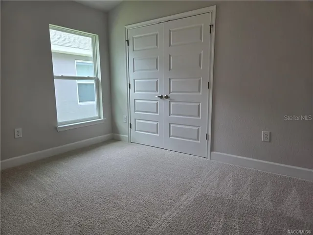 an empty room with closet area