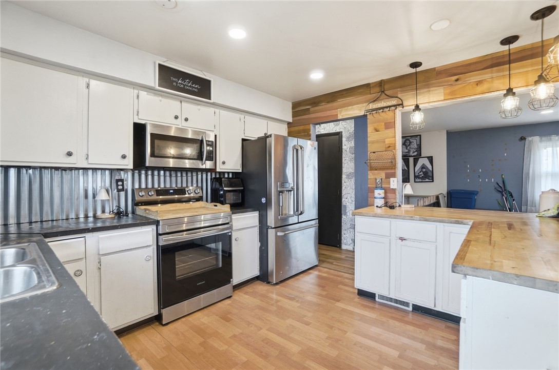290 Ginghamsburg Road Tipp City, OH 45371 - Photo 20 of 49 This spacious kitchen offers ample countertop space, modern appliances, and a bright, inviting atmosphere.
