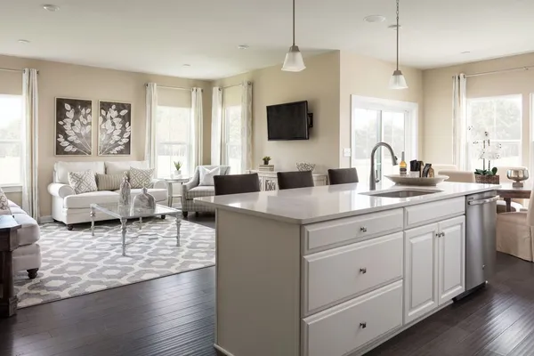 a living room with furniture a flat screen tv and a window