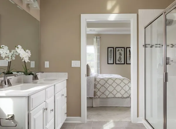 a en suite bathroom with a double vanity sink and a mirror