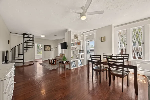 a view of a a dining room with furniture window and wooden floor