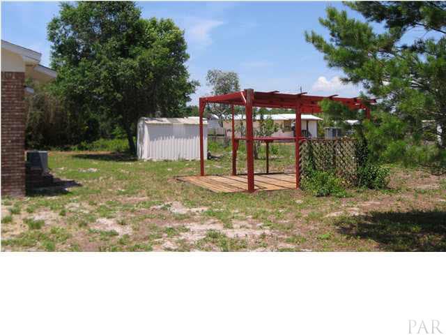 Back yard showing gazebo and storage building