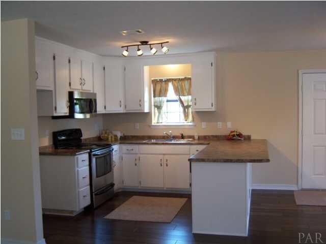 Kitchen view with new floors, counter tops and appliances