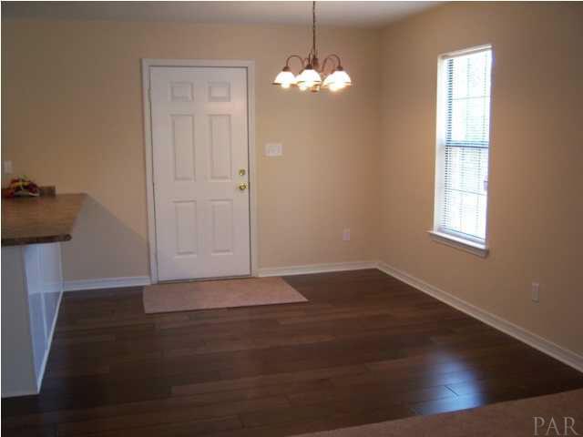 Dining area and breakfast bar with hardwood floors