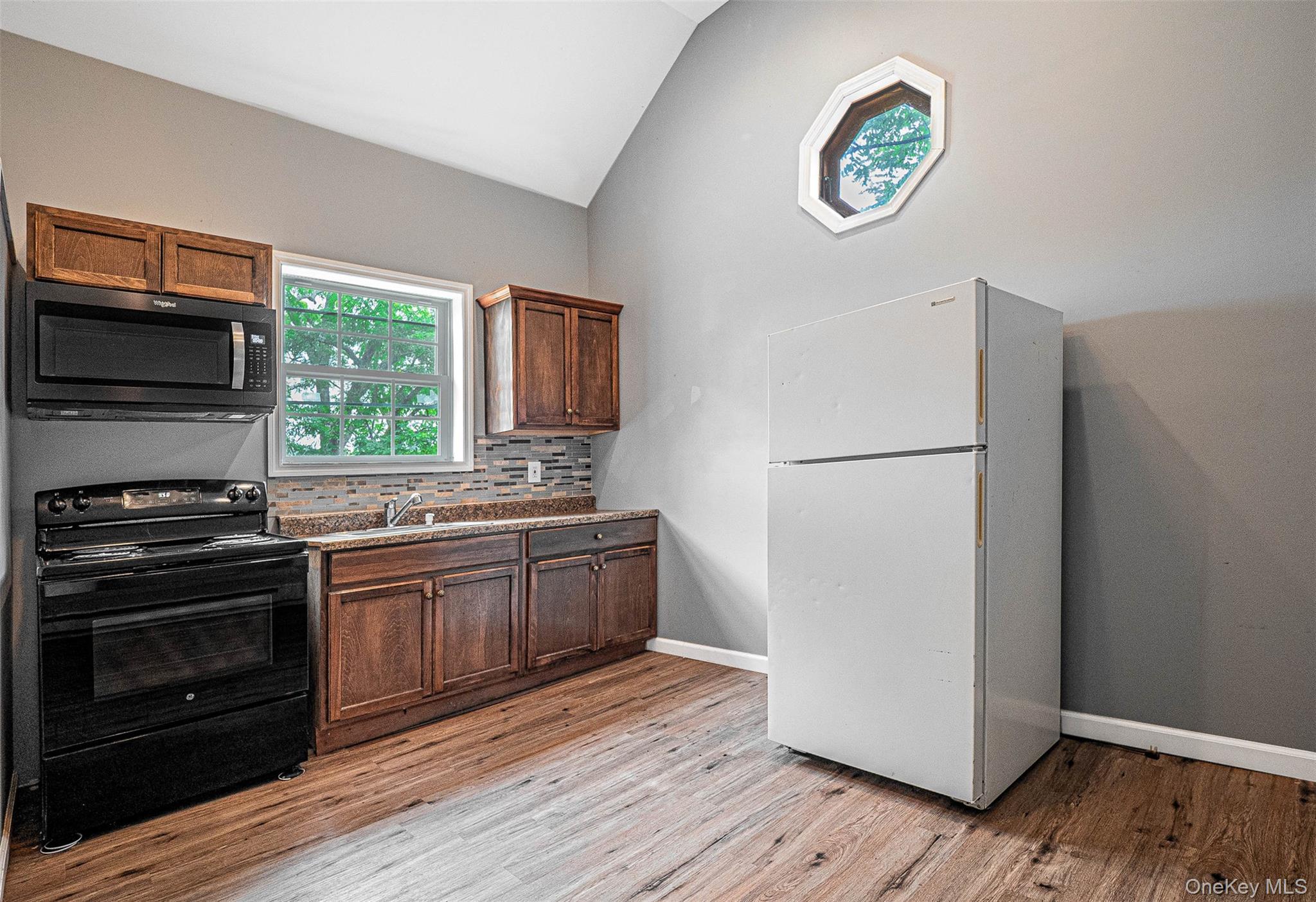 784 County Rte 12 New Hampton, NY 10958 - Photo 9 of 19 a kitchen with a refrigerator and a stove top oven