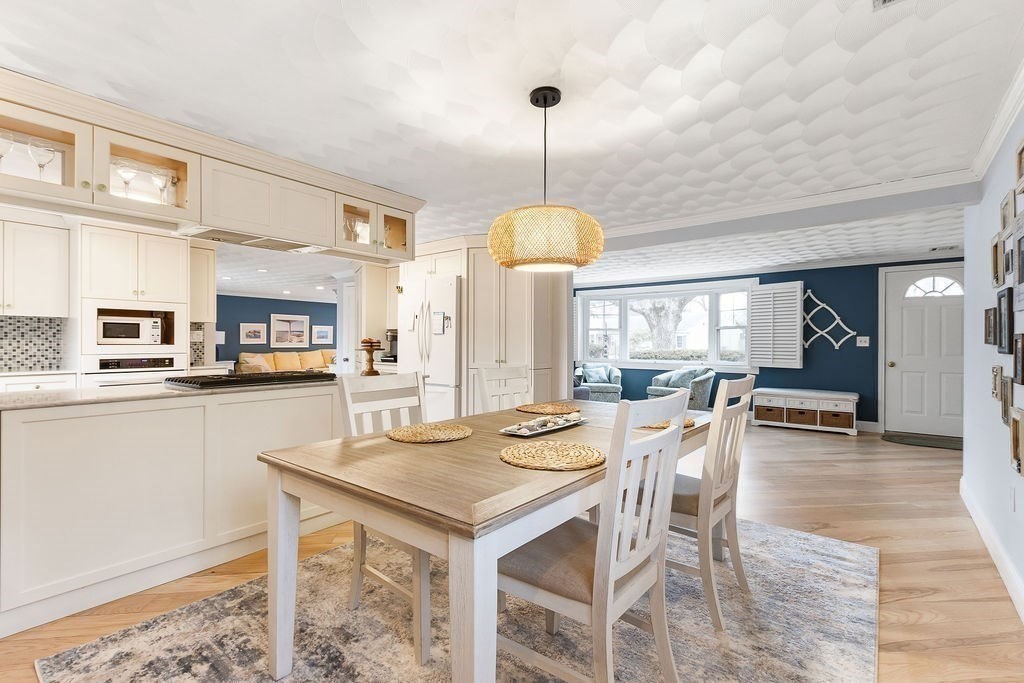 3 Oxbow Road Natick, MA 01760 - Photo 11 of 29 a view of a dining room and livingroom with furniture wooden floor a chandelier