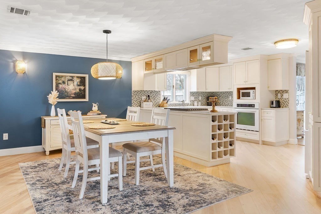 3 Oxbow Road Natick, MA 01760 - Photo 6 of 29 a kitchen with stainless steel appliances kitchen island granite countertop a table chairs and a refrigerator