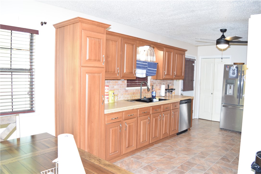 24772 County Road 360 Mathis, TX 78368 - Photo 6 of 30 a kitchen with stainless steel appliances granite countertop a refrigerator and a sink