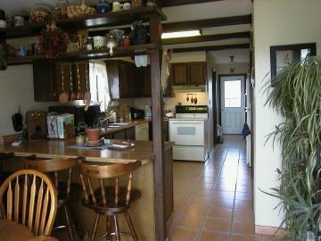3194 226th Road Silt, CO 81652 - Photo 3 of 6 a kitchen with a table chairs refrigerator and cabinets