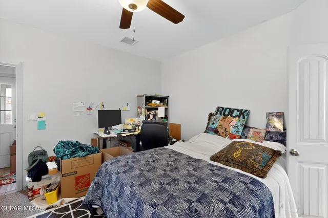 a bedroom with bed and a chandelier