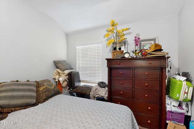 a bedroom with a bed and a dresser
