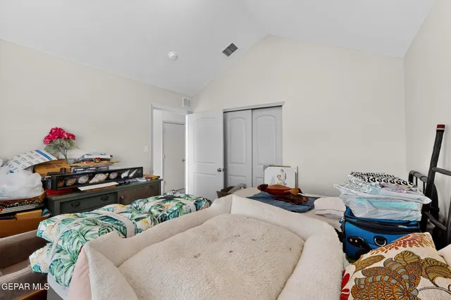 a bedroom with bed and a couch