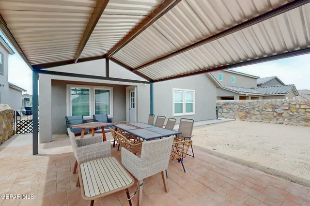 a outdoor dining space with furniture and couch