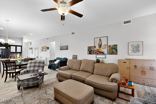 a living room with furniture and kitchen view