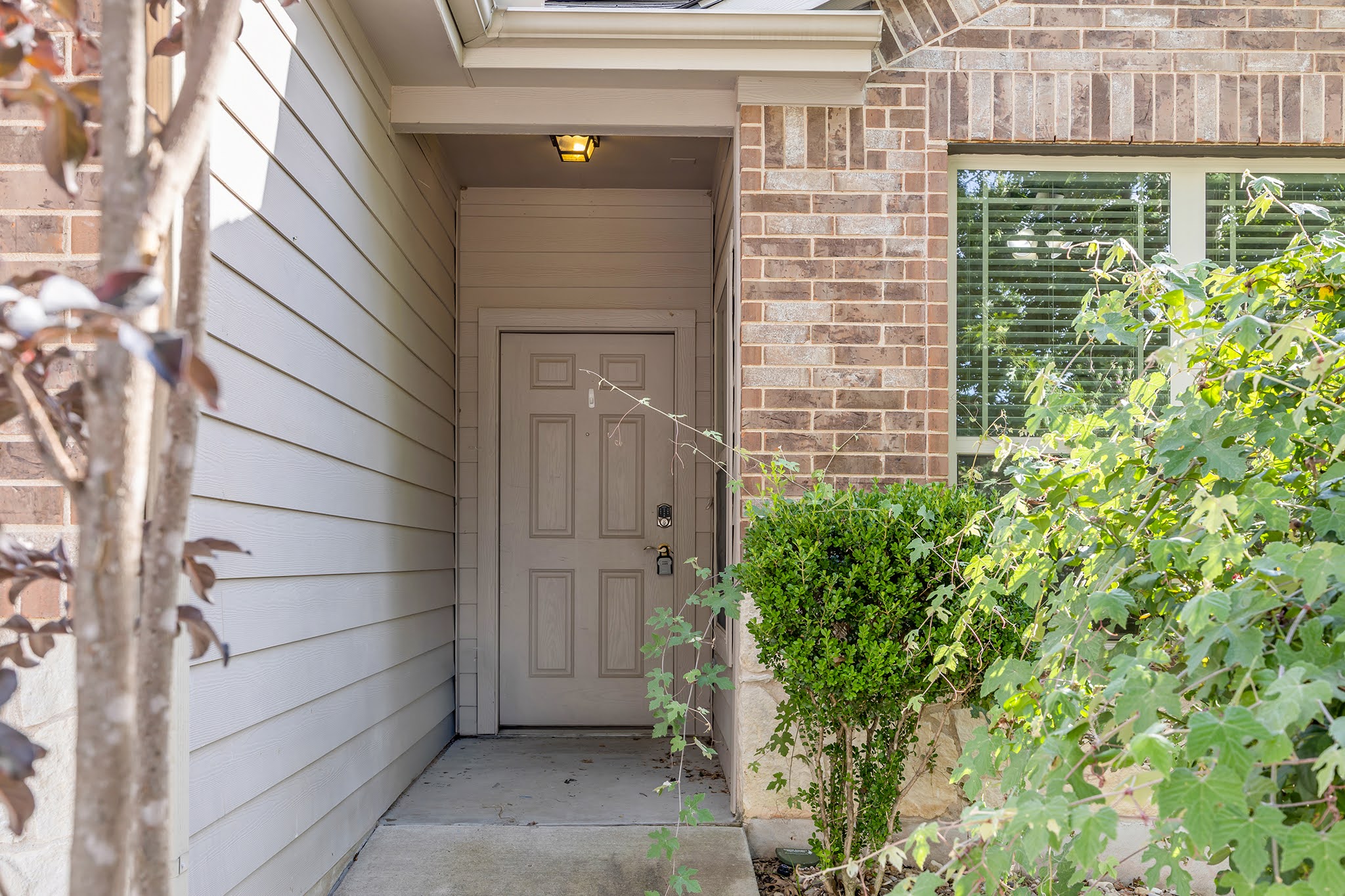 7212 Vail Ridge Street Austin, TX 78744 - Photo 24 of 26 A welcoming entry framed by brick and siding, inviting visitors into a charming residence.