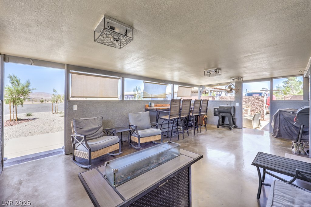 4375 Pinwheel Street Logandale, NV 89021 - Photo 31 of 52 An inviting outdoor living space features sleek flooring and expansive windows, perfect for entertaining.