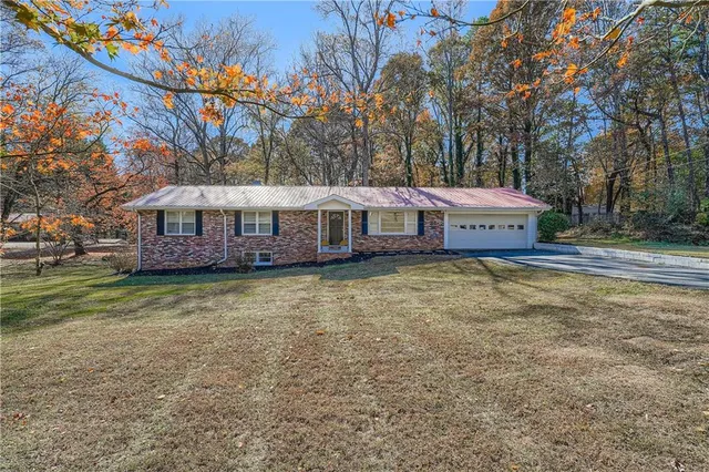 a view of a house with a yard patio and deck