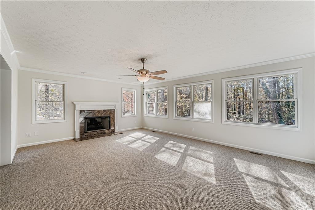 6797 Campground Road Cumming, GA 30040 - Photo 14 of 28 a view of an empty room with a fireplace and a window
