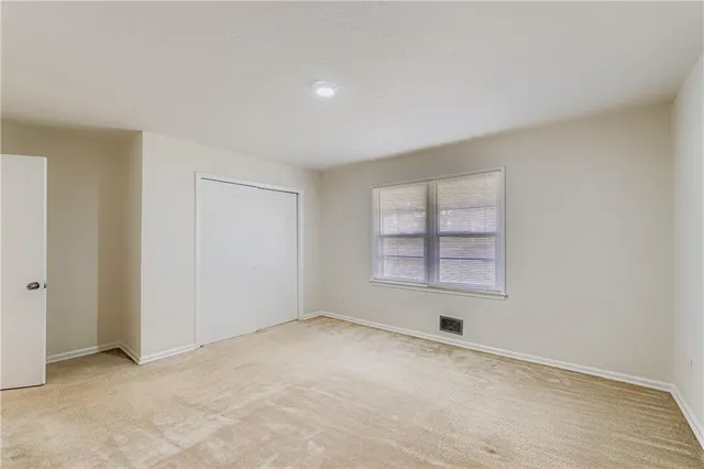 an empty room with a empty space and windows