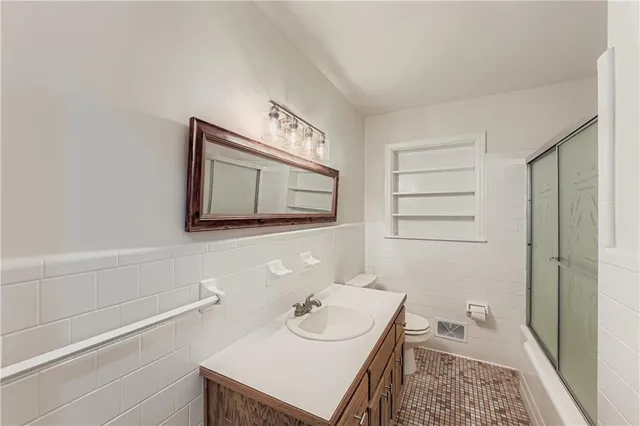 a bathroom with a sink a toilet and vanity