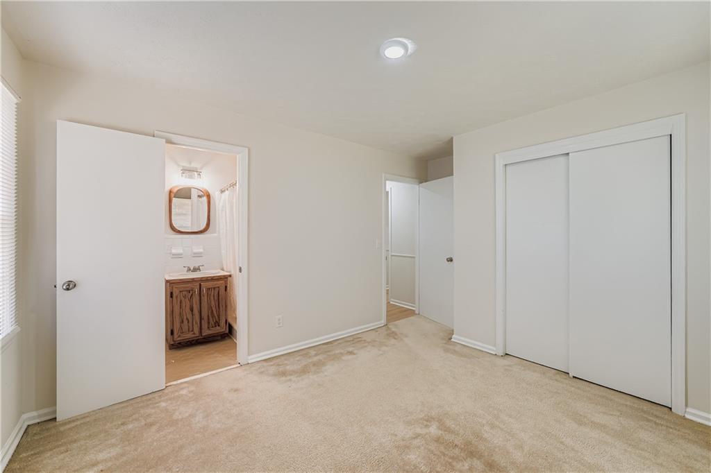 6797 Campground Road Cumming, GA 30040 - Photo 19 of 28 an empty room with cabinet and mirror