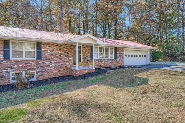 a front view of a house with garden