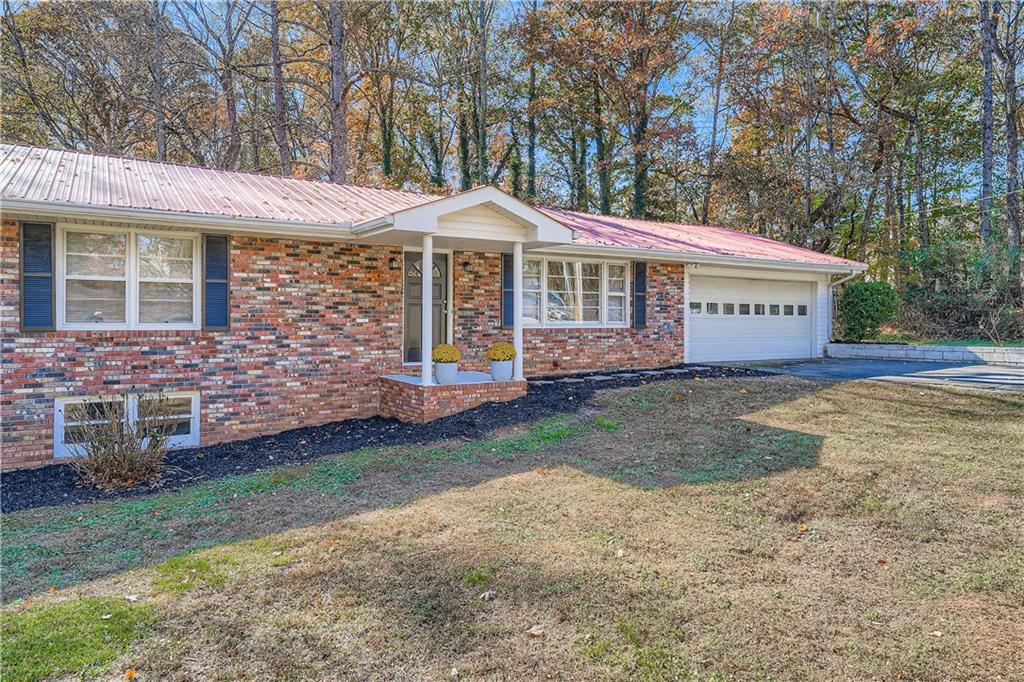 6797 Campground Road Cumming, GA 30040 - Photo 2 of 28 a front view of a house with garden