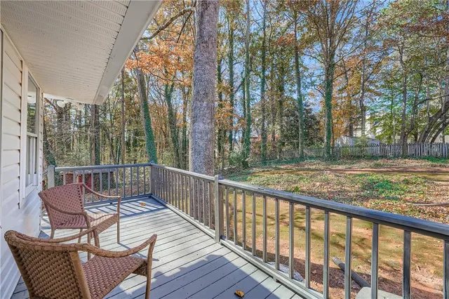 a view of balcony with wooden floor and outdoor seating