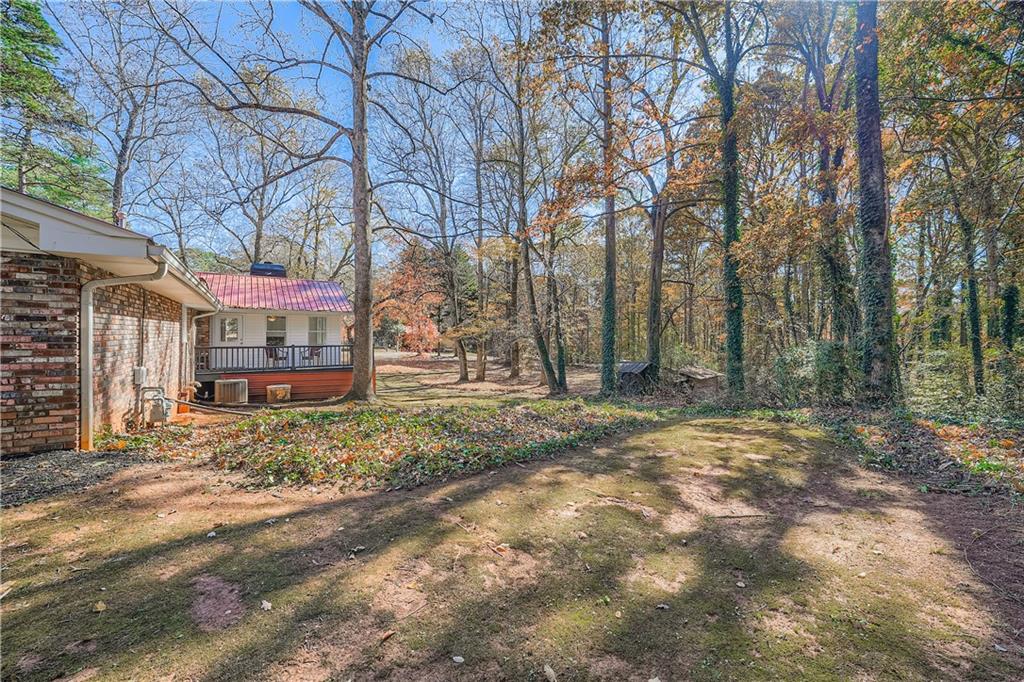 6797 Campground Road Cumming, GA 30040 - Photo 26 of 28 a backyard of a house with barbeque oven and outdoor seating