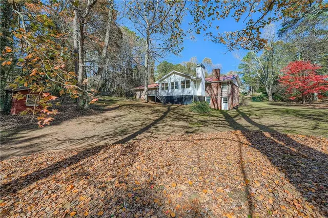 a view of a large house with a yard covered with snow