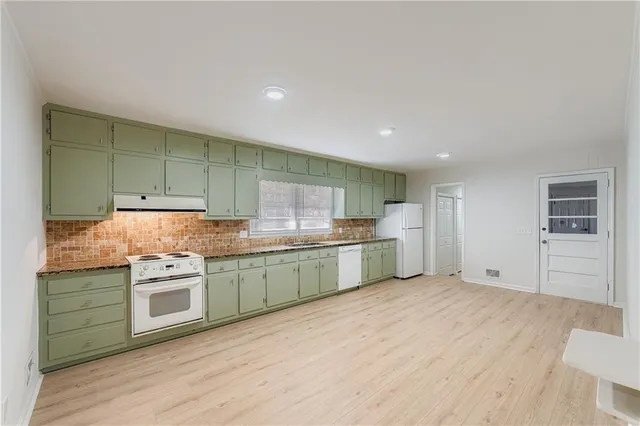 a kitchen with stainless steel appliances granite countertop a sink and cabinets