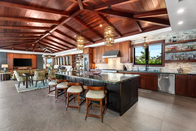 a large kitchen with a table and chairs
