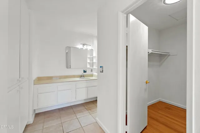 a bathroom with a shower sink vanity mirror and toilet