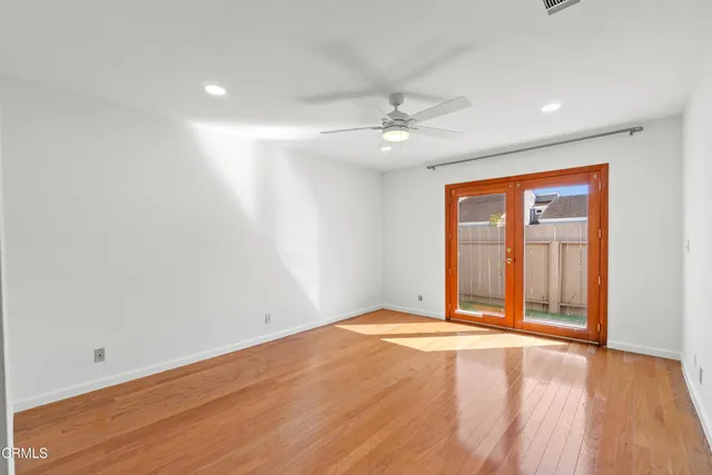a view of empty room with wooden floor