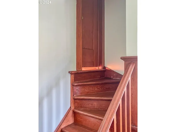 wooden floor with table and a mirror