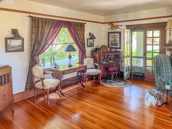 a living room filled with furniture and a wooden floor