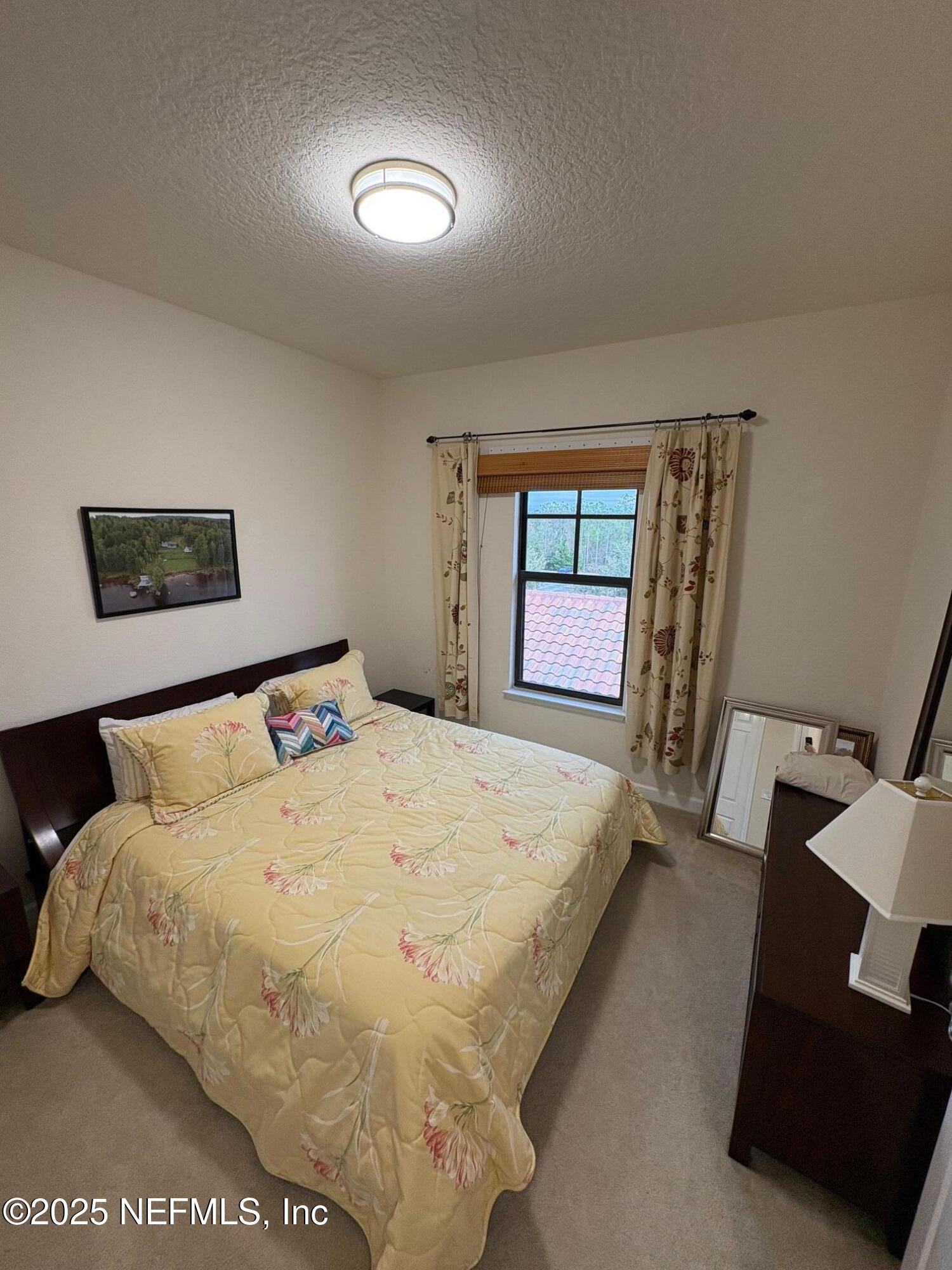 544 Market Street St. Augustine, FL 32095 - Photo 15 of 17 a spacious bedroom with a bed and a window