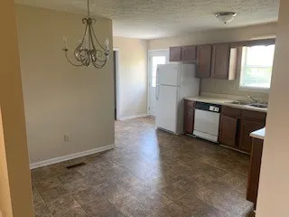 a kitchen with stainless steel appliances granite countertop a sink and a refrigerator