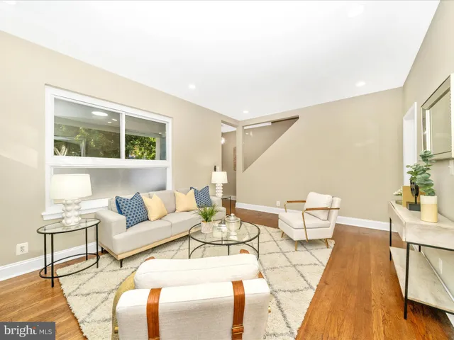 a living room with furniture and a dining table