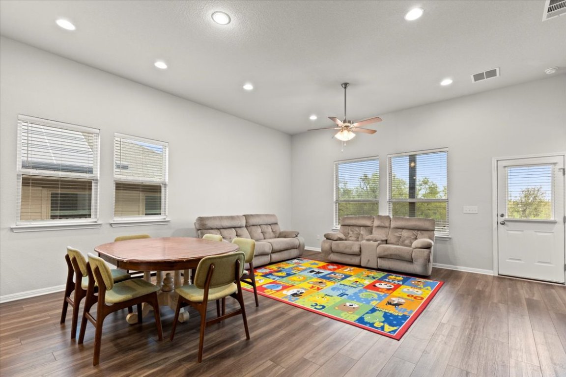 213 Munk Lane Leander, TX 78641 - Photo 14 of 40 a dining room with furniture and wooden floor