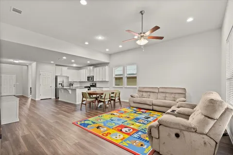 a kitchen with stainless steel appliances granite countertop white cabinets and a stove