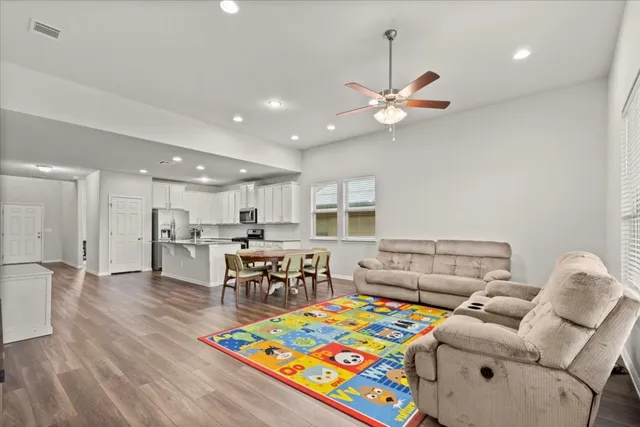 a kitchen with stainless steel appliances granite countertop white cabinets and a stove