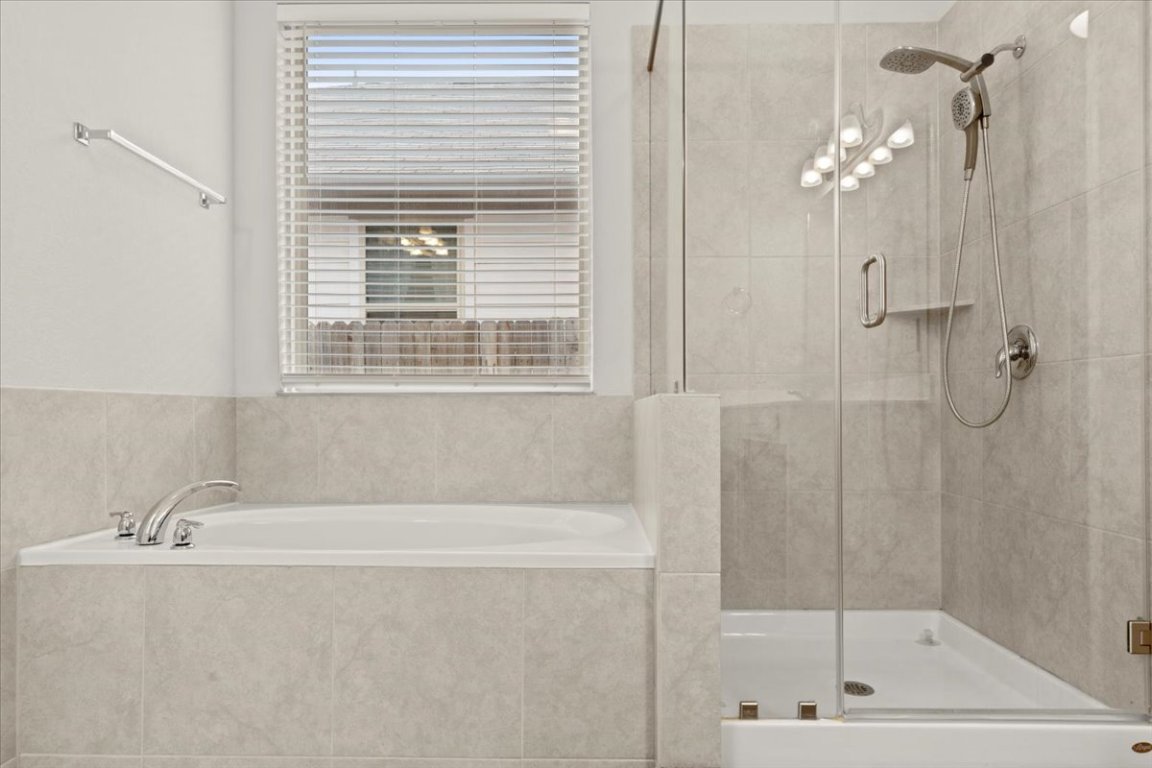 213 Munk Lane Leander, TX 78641 - Photo 19 of 40 a bath tub sitting next to a shower