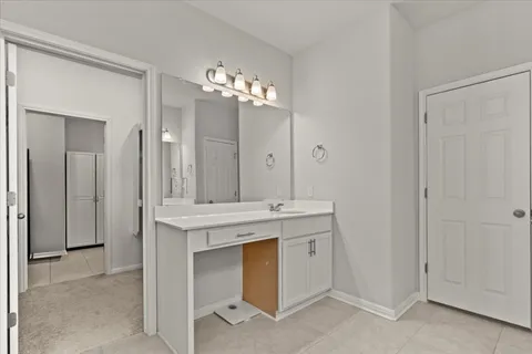 a bedroom with a large bed and a ceiling fan