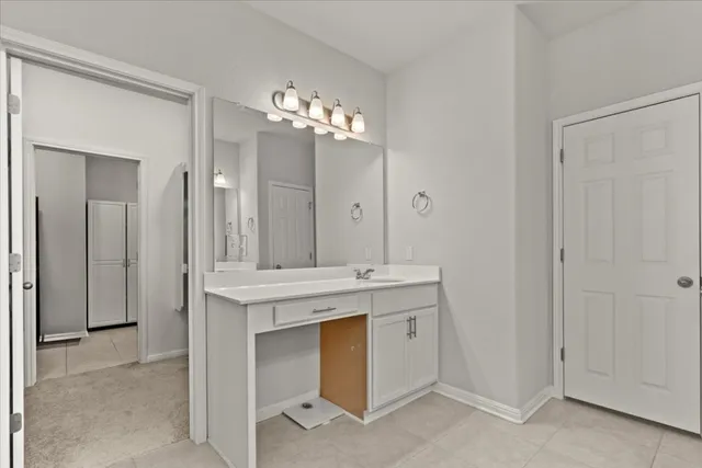 a bedroom with a large bed and a ceiling fan