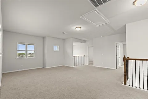 a spacious en suite bathroom with a granite countertop sink a toilet and a mirror