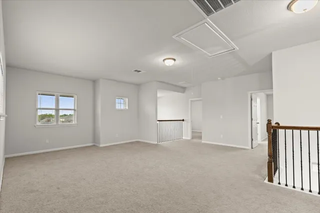 a spacious en suite bathroom with a granite countertop sink a toilet and a mirror