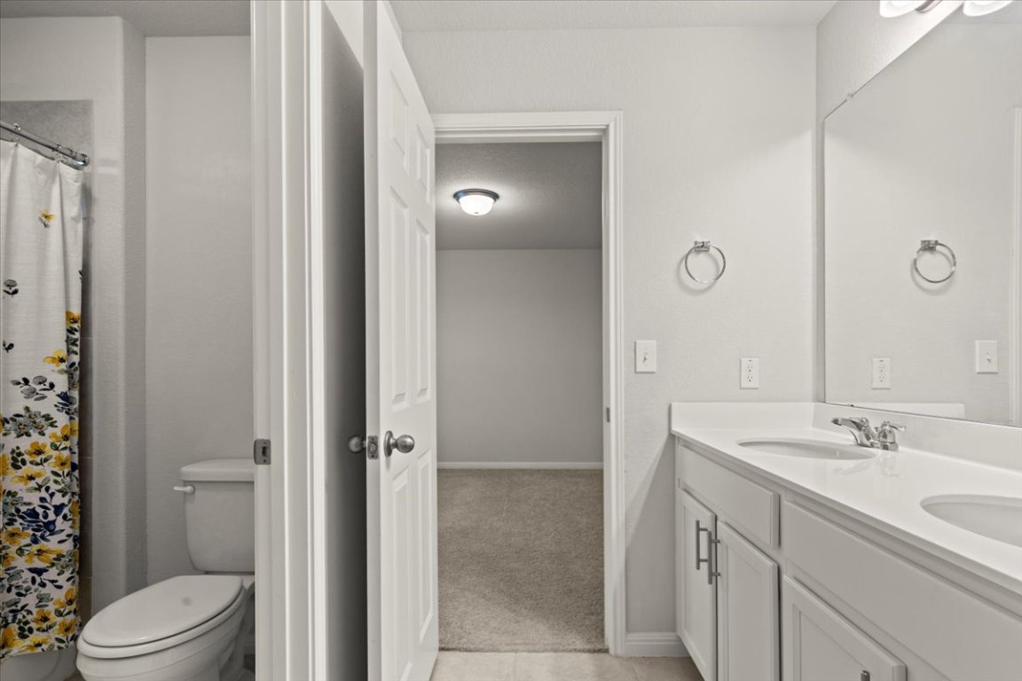 213 Munk Lane Leander, TX 78641 - Photo 31 of 40 a bathroom with a sink a toilet and shower